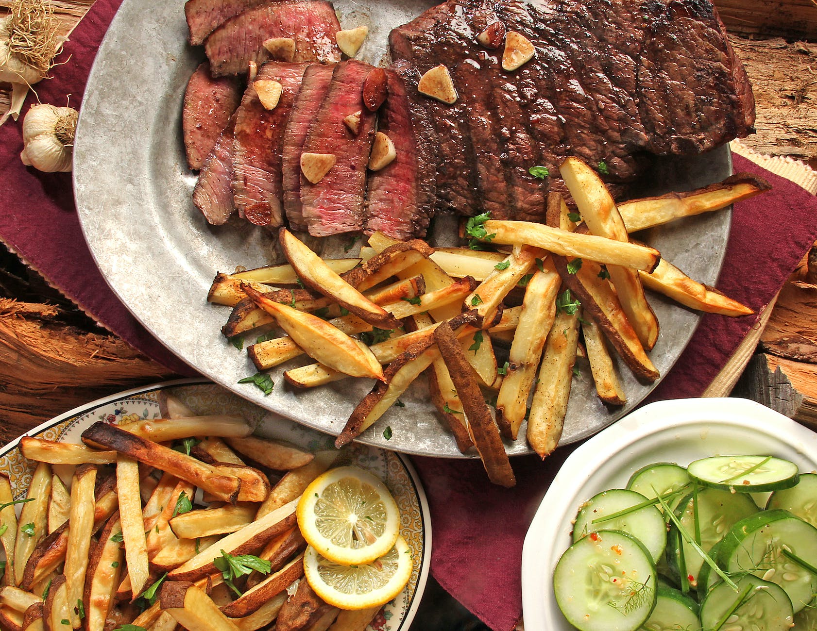 steak and french fries on gray plate